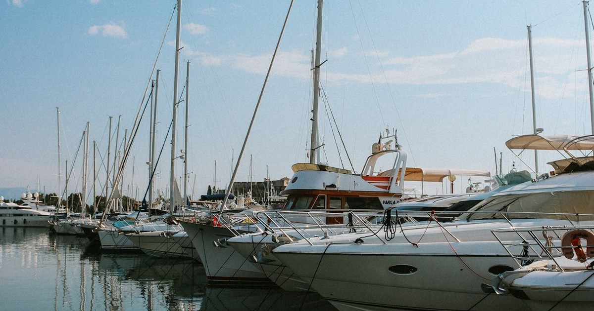 Scenic route view of the Ionian Sea with sailboats anchored in a secluded bay